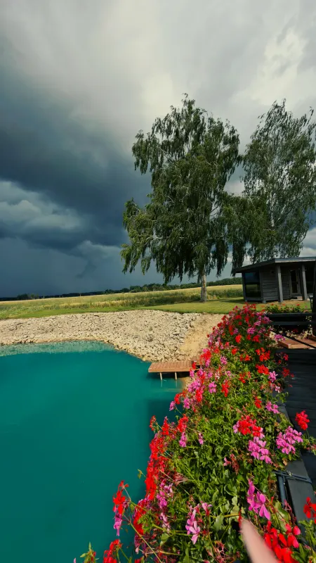 The pond and storm clouds over the fields
