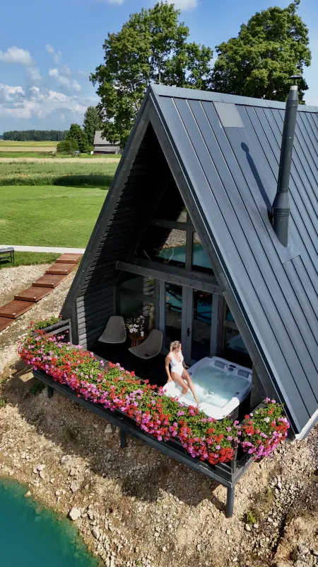 The outdoor hot tub on the flower-lined terrace
